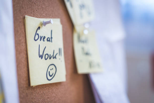 istock Employee motivation and leadership concept. “Great work” note on pinned paper, cork board 1295757512