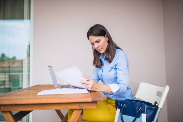 istock Young woman working on her balcony at home 1295757852