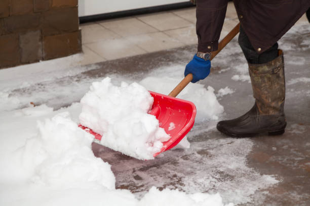 istock Snow removal. Red plastic shovel cleans snow from yard 1295759014