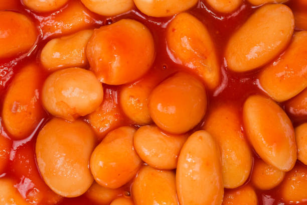 istock Beans stewed with tomato sauce close-up, background 1295759047