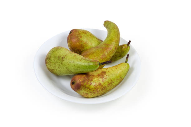 istock Pears of variety Conference on a white dish 1295759093