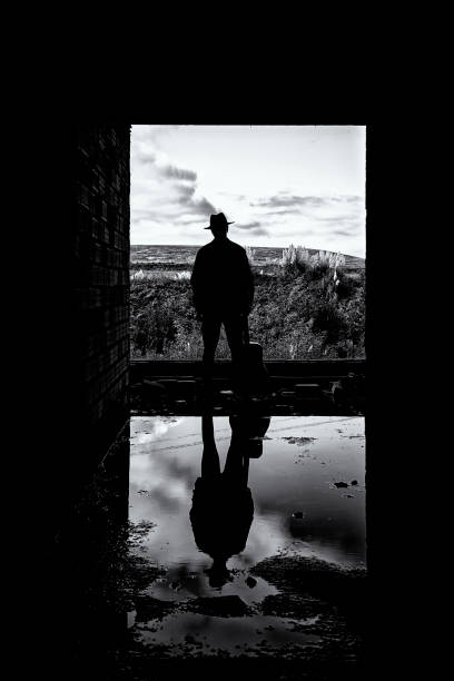 istock A young man with his guitar and reflection on the water 1295759174