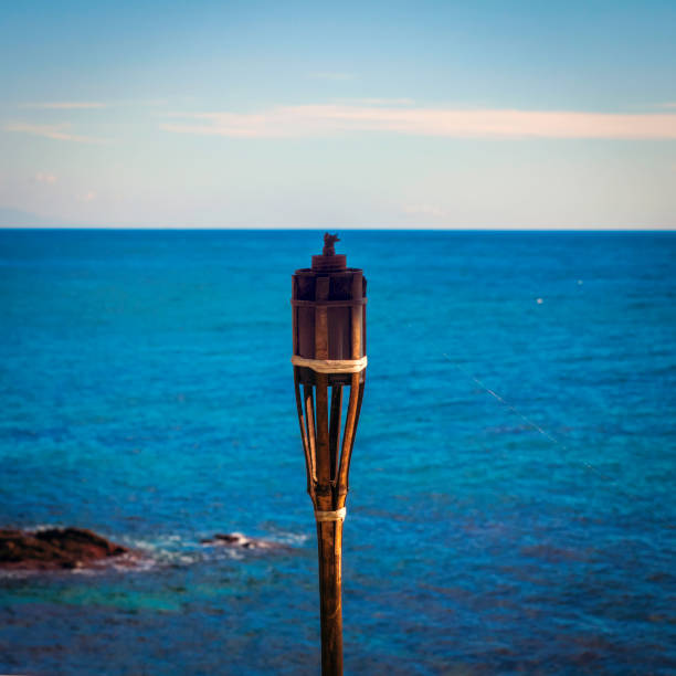 A torch extinguished in front of the sea of the coast of Mijas