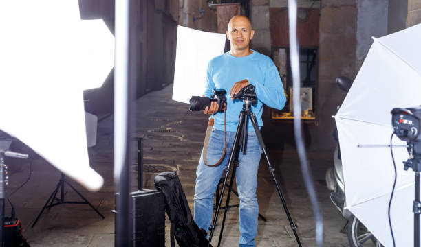 istock Professional photographer  holding camera 1295759370