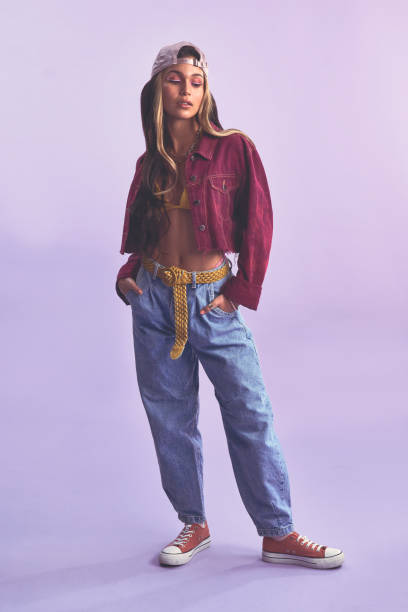 Studio shot of a beautiful young woman posing against a purple background