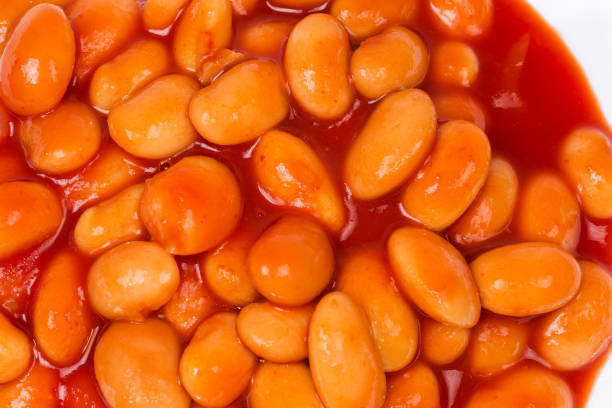 istock Part dish with stewed beans in tomato sauce, top view 1295760212