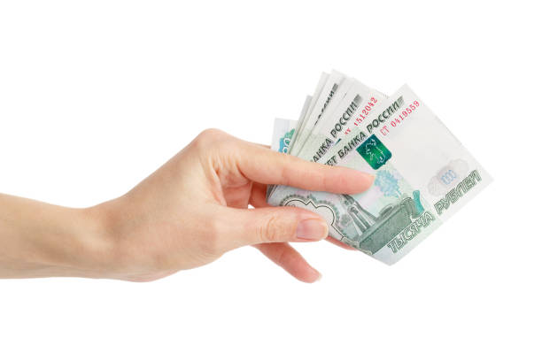 istock Hand with Russian rubles, isolated on white 1295760832