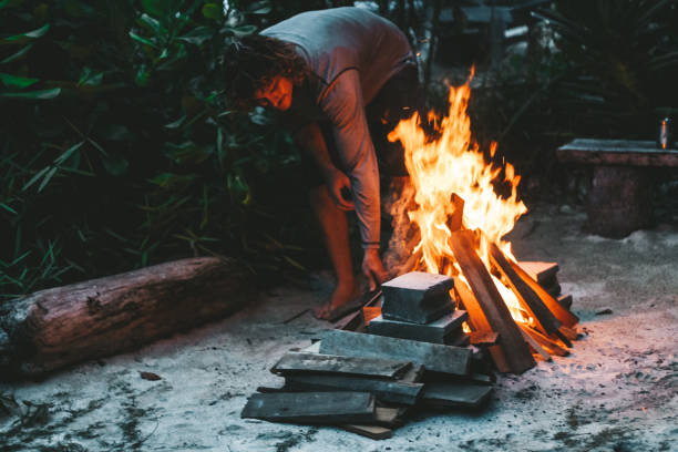 istock Men putting wood on the fire 1295761712