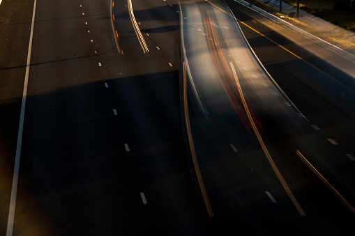 Motion trails of vehicles on freeway early morning