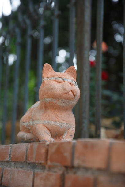 istock Kitten carved on red brick wall 1295763166