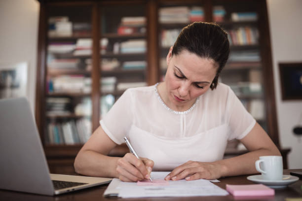 istock Young business woman working at home 1295763304