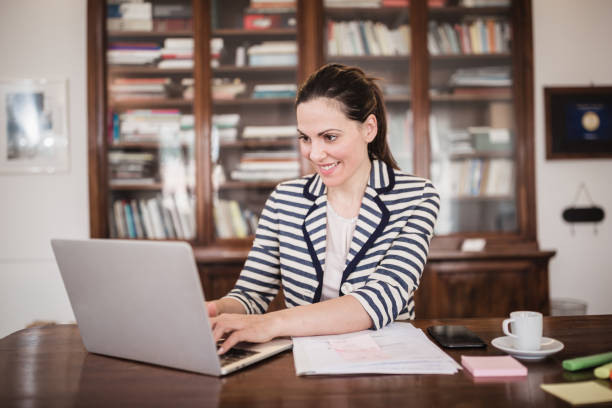 istock Young business woman working at home 1295763340