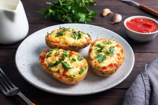 baked potatoes in the peel stuffed with cheese with garlic and herbs. - potato skin imagens e fotografias de stock