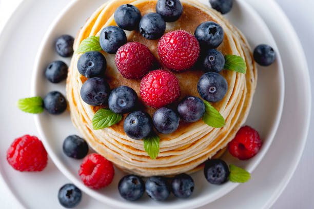 istock Traditional Russian pancakes with berries. Maslenitsa week. Pancake week 1295765662