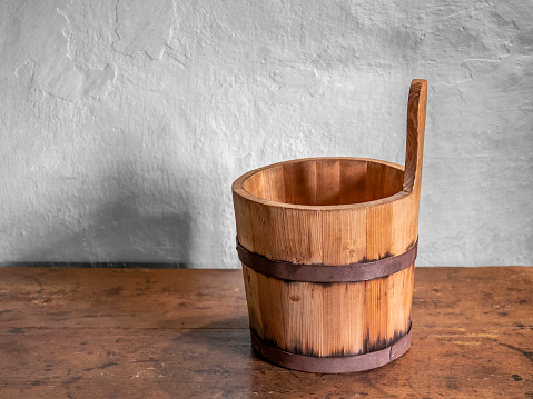 historic wooden bucket on wooden table