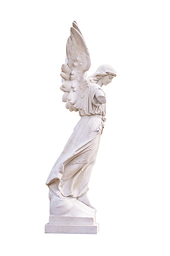 Ancient white marble angel sculpture,  seen on tombstone in a graveyard in Lugo city, Galicia, Spain. Clear blue sky background.