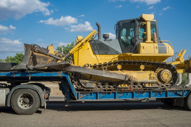 istock Heavy-duty truck carrying bulldozer equipped with multishank ripper 1295766026