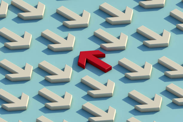 istock Red arrow facing the opposite direction white arrows. 1295767395