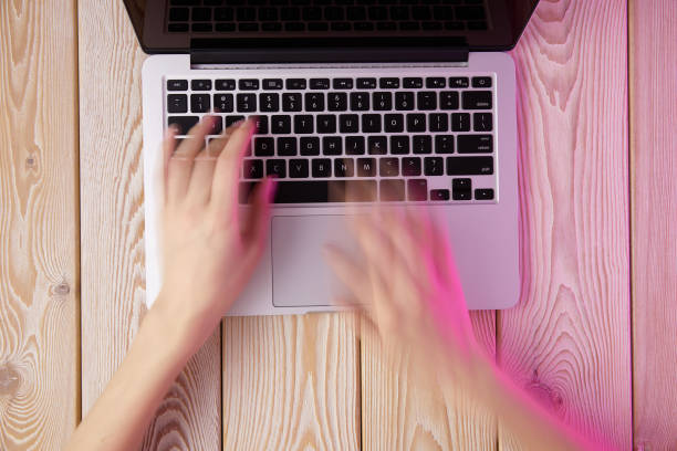 Image of woman"u2019s hands typing fast on laptop keyboard. View from above. Remote work concept image. stock photo