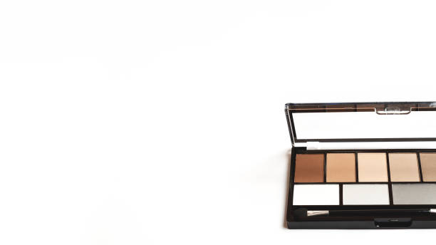 istock neutral brown eye shadow palette on white background. Female decorative cosmetics. Copy space 1295768855