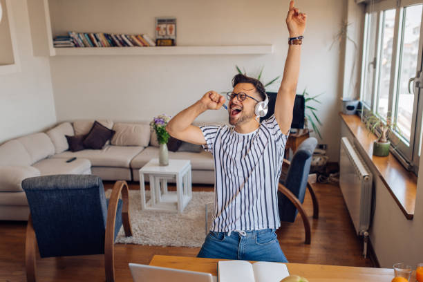 istock Young man enjoying an online dancing party at home 1295768939