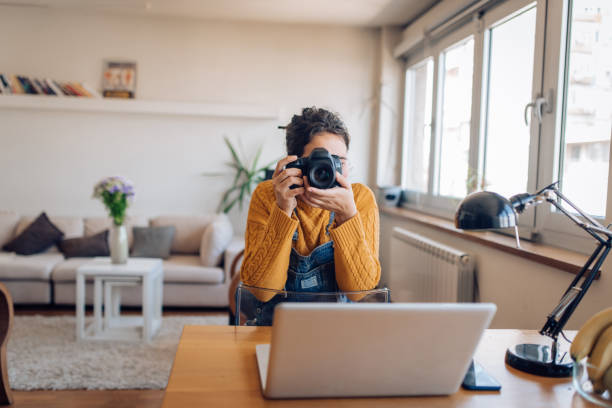 istock Young woman making photos at home 1295769182