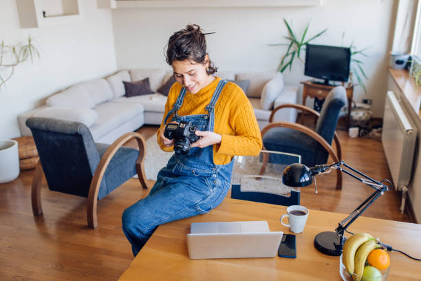 istock Young photographer looking at the photos she made 1295769185