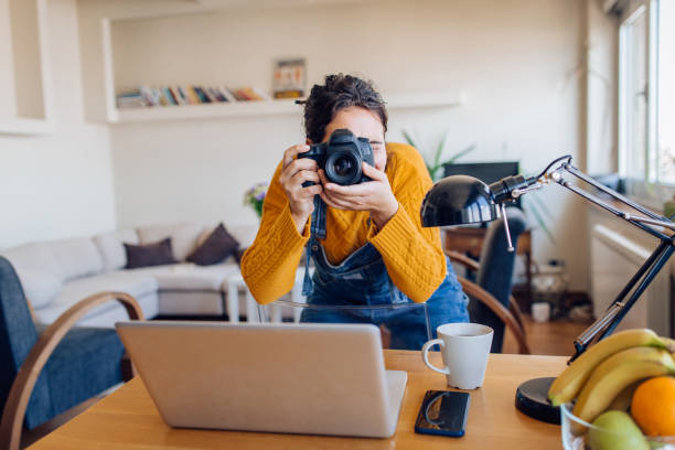 istock Young photographer testing her camera at home 1295769195