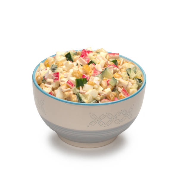 istock Salad with corn, crab sticks, cucumbers, eggs and mayonnaise in a bowl 1295772242