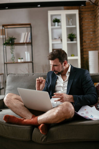 istock Businessman with no pants working at home. 1295772441