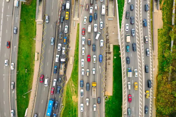 Aerial drone view of highway with busy urban traffic in modern city. Traffic jam from above.