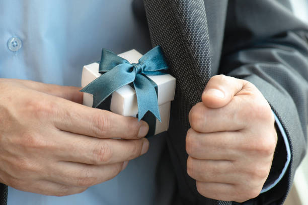 istock Businessman giving Gift Box 1295774847