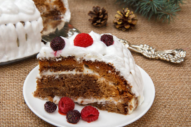 istock Sliced biscuit cake decorated with whipped cream and raspberries 1295774995