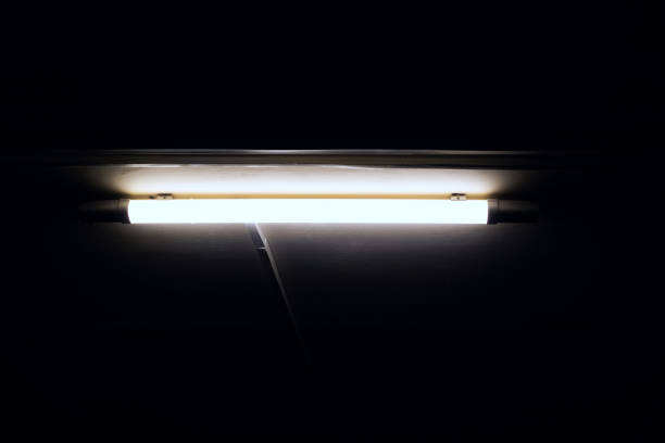 istock Long bright LED lamp on the ceiling in the dark 1295777305