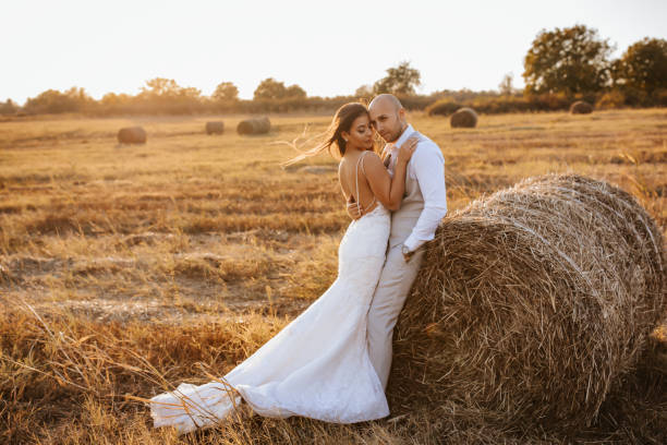 istock Wedding couple in a hay field 1295777332