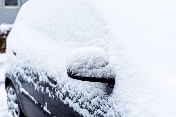 istock Side view of a snow-covered black car 1295777622