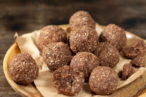 istock Chocolate coconuts. Chocolate balls with coconut. Chocolate candies or cookies with coconut, cinnamon and powdered sugar 1295778590