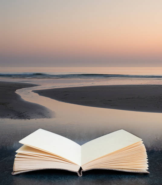 digital composite of beautiful colorful vibrant sunrise over low tide beach landscape peaceful scene in pages of open book - bamburgh beach imagens e fotografias de stock