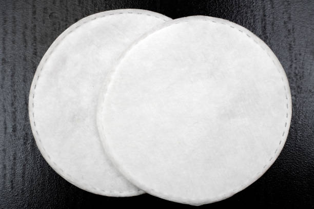 istock Cotton pads on a black table close-up 1295779319
