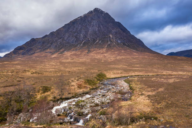Flying drone epic landscape image of Buachaille Etive Mor and surrounding mountains and valleys in Scottish Highlands on a Winter day Flying drone dramatic landscape image of Buachaille Etive Mor and surrounding mountains and valleys in Scottish Highlands on a Winter day buachaille etive mor photos stock pictures, royalty-free photos & images
