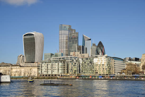 City of London skyline and River Thames, UK London, United Kingdom - December 15 2020: Daytime panorama of the City of London skyline and River Thames with a clear blue sky. waterloo bridge stock pictures, royalty-free photos & images