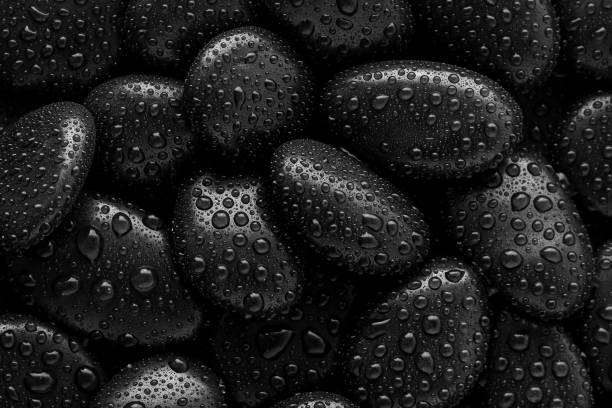 istock Black Stones.rock background and water drop 1295782571