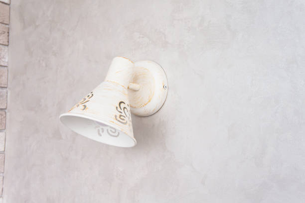 beautiful sconce in white in vintage style on a textured light wall