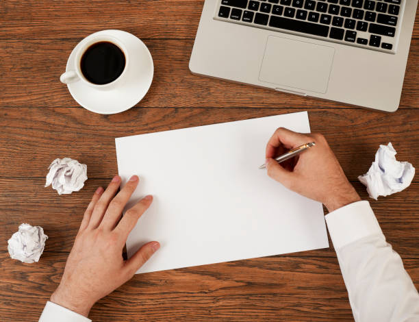 istock Man with pen and blank paper 1295782967