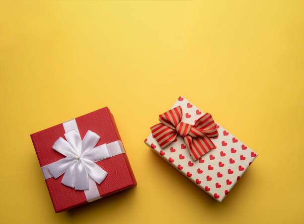 istock Red and white gift box with on yellow background,flat lay 1295783073