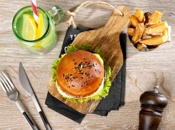 istock Cheeseburger with fries and drink 1295783096