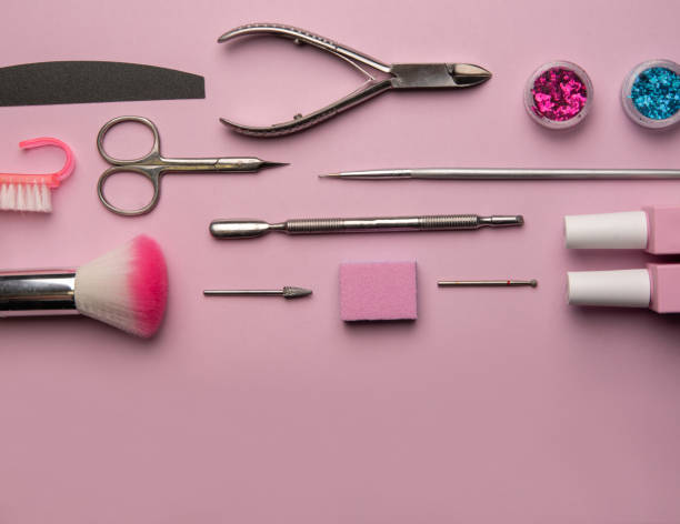 istock Set of manicure tools and accessories on a pink background. Hardware manicure,Flat lay. 1295783142