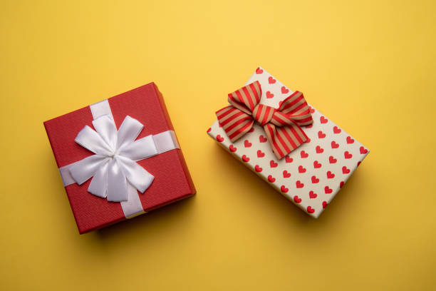 istock Red and white gift box with on yellow background,flat lay 1295783256