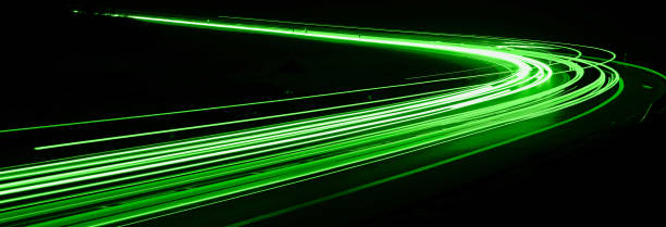 istock green car lights at night. long exposure 1295783408