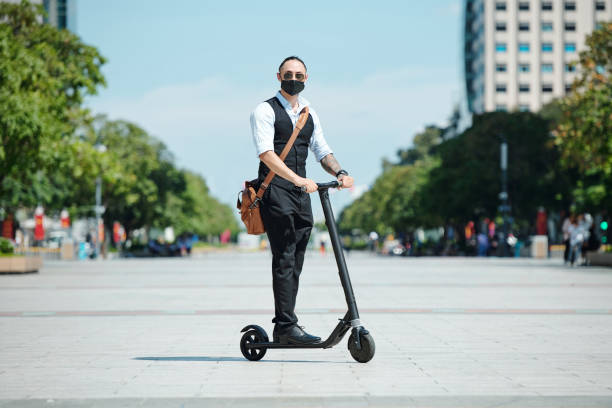 istock Businessman riding on electric scooter 1295783973